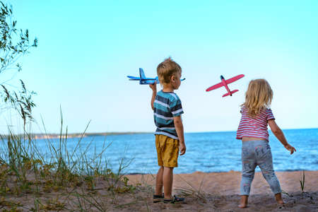 children children launching toy planes by the sea. no war conceptの写真素材