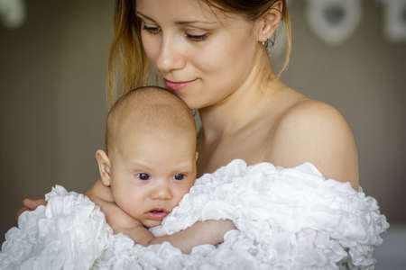 Young woman holding baby boy. Image with selective focusの写真素材