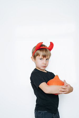 Halloween concept. cute little boy with red devil horns isolated on white background.の写真素材