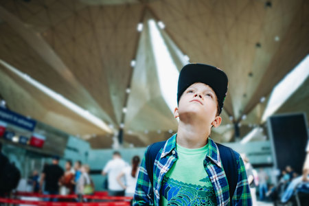cute caucasian boy in airport with backpack . Travelling concept. High quality photoの写真素材