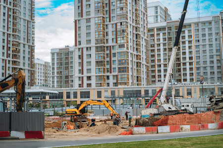 Unrecognizable workers and technical work at modern construction site of apartment recidential building in city.の写真素材