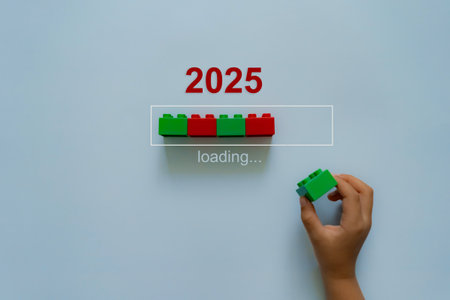 Loading new year 2024 to 2025 with child hand putting block in progress bar. Start new year 2025 with goal plan, strategy.の写真素材