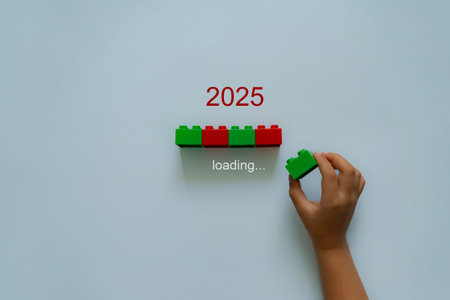 Loading new year 2024 to 2025 with child hand putting green plastic block in progress bar. Start new...