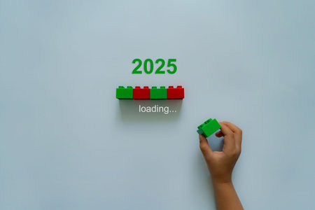 Loading new year 2024 to 2025 with child hand putting plastic block in progress bar.