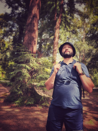 man with backpack travelling in rainforestの写真素材