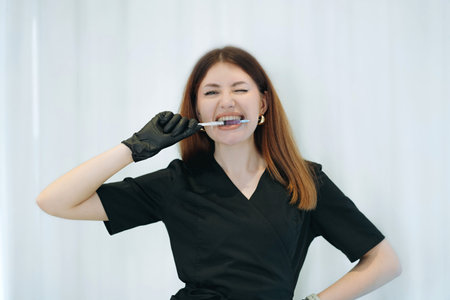 aesthetician woman professional wearing black medical suit holding syringes.