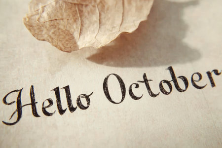 Hello October pastel coloured poster.Dry fallen oak leave on marble backgroundの素材