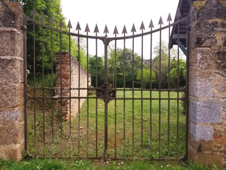 Old gate with lock and keyhole in the garden in summer.の写真素材