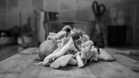 Mushrooms in a bowl on a wooden table. Black and white photo.の写真素材
