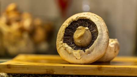Close up of champignon mushroom on a wooden cutting board.の写真素材