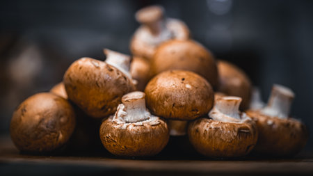 Fresh champignons on a wooden table. Selective focus.の写真素材