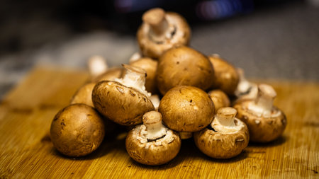 Fresh champignon mushrooms on a cutting board. Selective focus.の写真素材