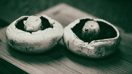 Champignon mushrooms on a wooden table. Selective focus. Toned.の写真素材