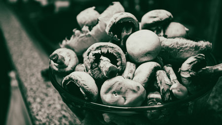 Fresh champignons in a glass bowl. Selective focus. Toned.の写真素材