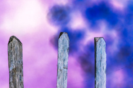 wooden fence with blue sky and clouds in backgroundの写真素材