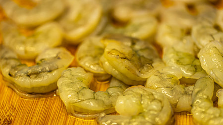 Close-up of peeled shrimps on a bamboo cutting boardの写真素材