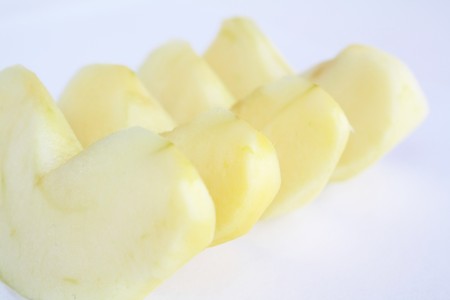 Bit s of apple fruits without skin on white backgroundの写真素材