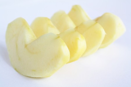 Bit s of apple fruits without skin on white backgroundの写真素材