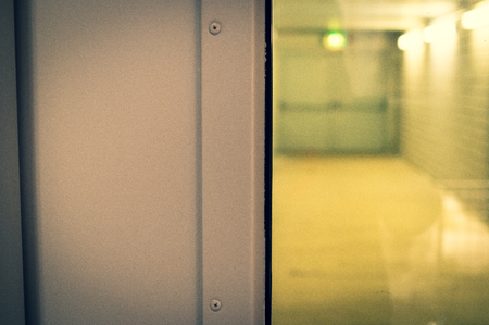 Emergency exit photographed in a building through a doorの写真素材