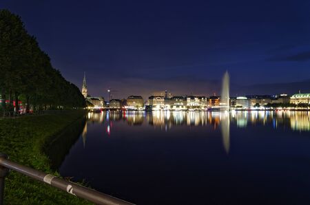 Hamburg Binnenalster at night in Germany with Alsterhaus and fountain in the background photographed on 2017.07.09のeditorial素材