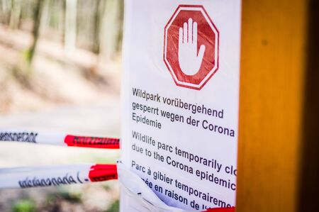 Sign at game park with in German Wildpark vorÃ¼bergehend gesperrt wegen Corona Epidemie in English Game park temporarily closed due to corona epidemic 02.04.2020 SaarbrÃ¼cken Germanyの写真素材