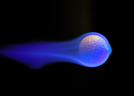 A flaming golf ball flies through the airの写真素材