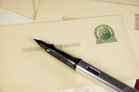 Fountain pen with antique cards with postageの写真素材