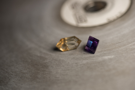 Amethyst and sunstone on a faceting lap with shallow depth-of-field.の写真素材