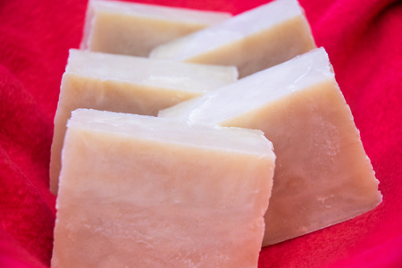 Hand crafted soaps on a red cloth.の写真素材
