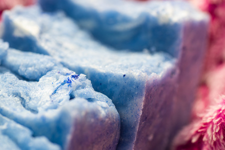 Blue hand crafted soaps on a fuzzy pink cloth.の写真素材