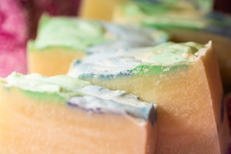 Multiple bars of hand crafted soap with colorful tops.の写真素材