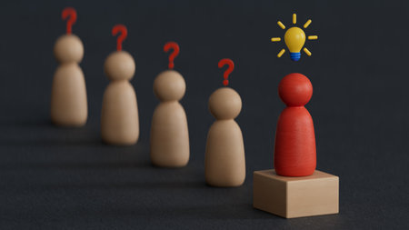 Conceptual image of leadership and success. Wooden figures with question mark and light bulb.の写真素材