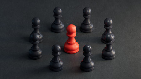 Leadership concept with black and red pawns on a black backgroundの写真素材