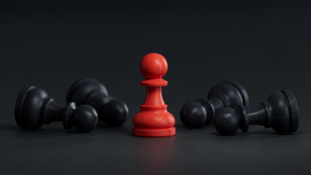 Black and red chess pawns on a black background. The concept of leadership.の写真素材