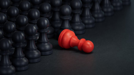 Black and red chess pawns on a black background, business conceptの写真素材