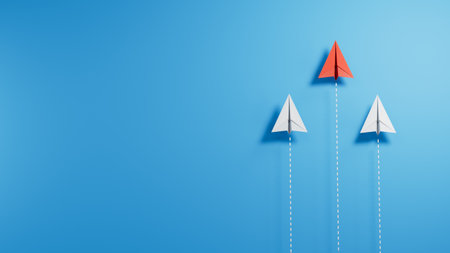 Leadership concept with paper plane and red paper plane on blue backgroundの写真素材
