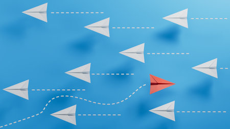 Leadership concept with red paper plane leading among white ones on blue backgroundの写真素材