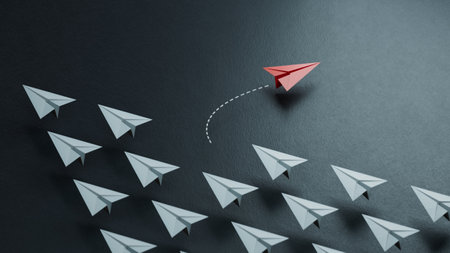 Red paper plane floating between others on light black background, flat lay. Uniqueness concept.new ideas. paper art style. creative idea.3D rendering on black background.の写真素材
