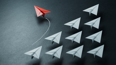 Individuality concept. Individual and unique leader red paper plane flies to the side. 3D illustration.3D rendering on black background.の写真素材