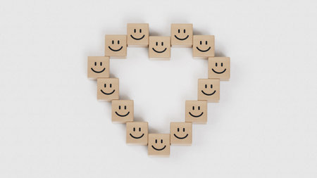 Wooden blocks with happy smiling face icon arranged in heart shape on white background, top view....
