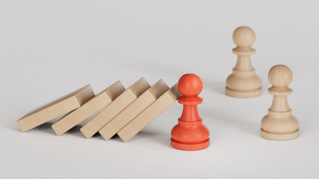 Wooden figurines representing leader stopping the domino falling over the employees. Business...