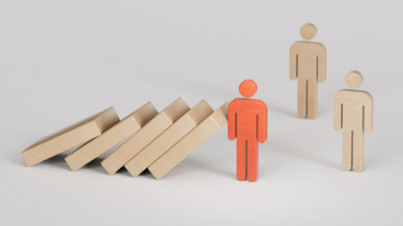 Wooden dolls representing leader stopping the domino falling over the employees. Business strategy.Leadership with business success concept.3D rendering on whitebackground.の写真素材