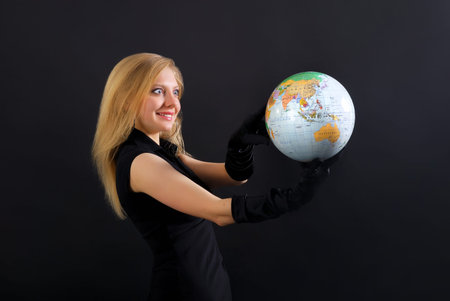 Pretty blonde with globe on black background
