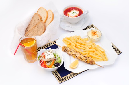 Complex lunch or dinner, food and drinks,  french fries, meat, soup, salad, juice, breadの写真素材