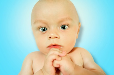 Very sweet and funny little baby, infant looks at usの写真素材