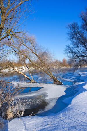 Winter river and blue skyの写真素材