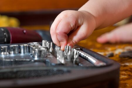 Child plays with a toolsの写真素材