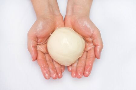 Hands holding the butter. Milk butter made at homeの写真素材