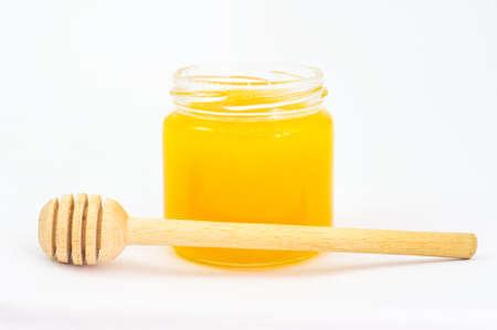 Jar of honey and dipperの写真素材