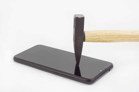 Hammer hits the screen of the phone. Safety glass phone.の写真素材